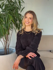 Natalie sitting on a chair and smiling