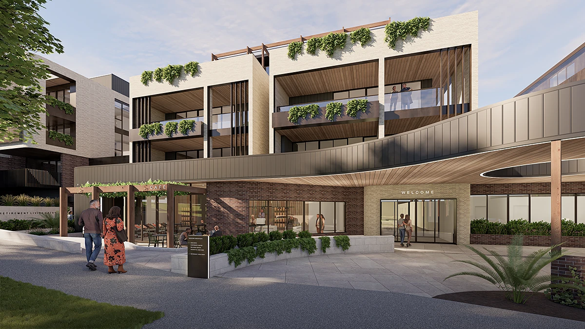 Architectural rendering of the main entrance to the BASSCARE Canterbury Community Centre and retirement living complex. It features a covered drop-off area with a circular canopy, a 'Welcome' sign, and an adjacent street-level café area with outdoor seating.